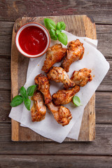 Grilled chicken drumsticks on paper