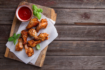 Grilled chicken drumsticks on paper