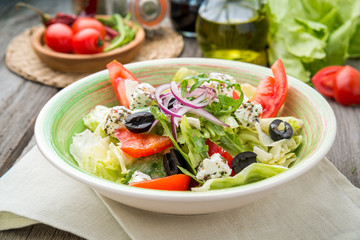 Greek salad with fresh vegetables, feta cheese and black olives