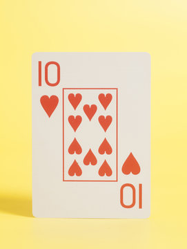 Playing cards - Ten of hearts on yellow background