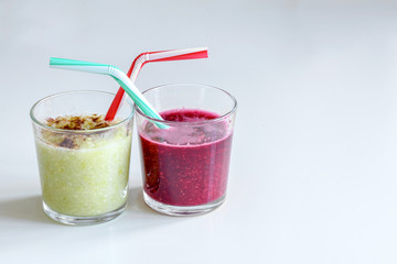 Delicious banana and raspberrry cocktails with drinking straws and cinnamon decoration. Clear background