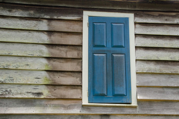 Fototapeta na wymiar Window with Blue Shutter