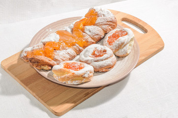 Appetizing homemade buns with orange fruit jam