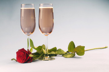 Concept with the rose relating to glasses of champagne