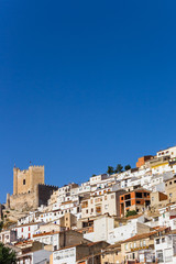 Fototapeta na wymiar White houses and castle tower of Alcala del Jucar