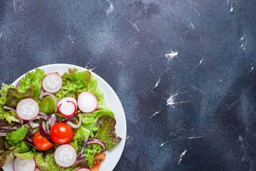 Healthy food - vegetables  salad on a dark background. Selective focus. Copy space. Top view