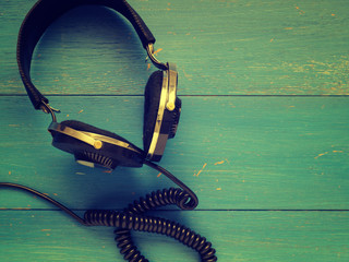 Old vintage headphones on wood