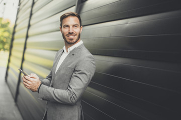 Successful businessmen entrepreneur using mobile phone outdoor