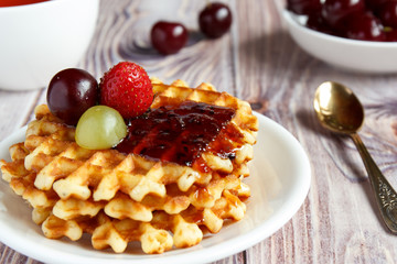 Tasty and healthy breakfast: waffles with fruit jam