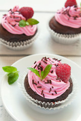 Freshly baked  muffins with mint and raspberry