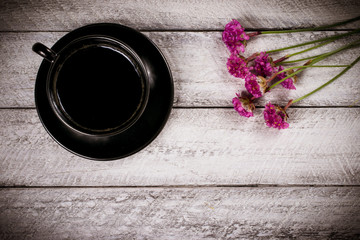 Fototapeta premium flowers and coffee cup on wooden table with copy space. celebration template concept.