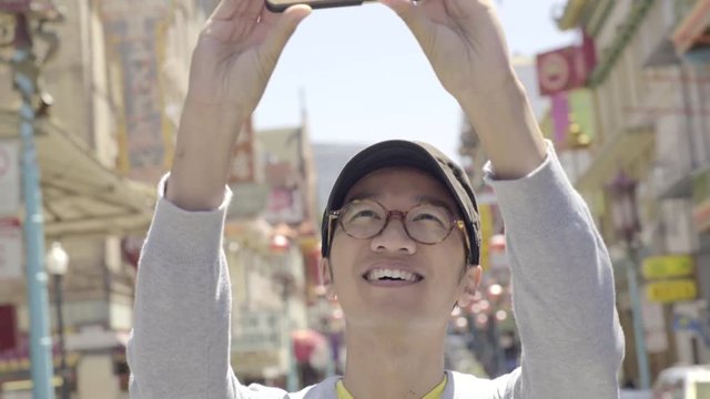 Tourist Takes A Panoramic Photo Of Chinatown, San Francisco With His Smart Phone 
