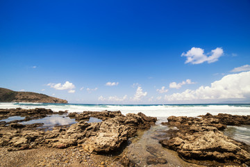 Fototapeta na wymiar Rock beach in south italy with rough sea