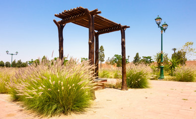 Fototapeta na wymiar Public Park with Bench in Marrakech, Morocco