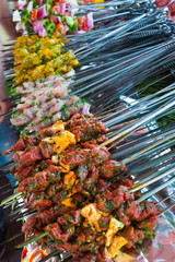 assorted skewers with meat, fish and vegetables on market in morocco