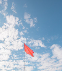 red flag flying in the blue sky