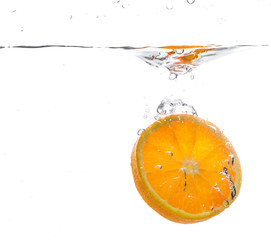 Fototapeta na wymiar orange slice in water splash. white background