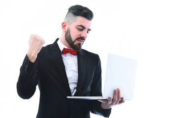 Bearded businessman in suit with happy smiling face holds computer