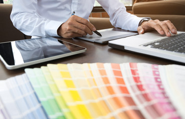 Graphic designer job with colour charts at a modern office
