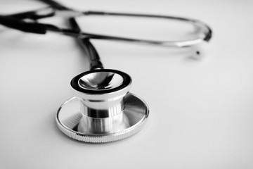 Close up of stethoscope on white background - health and care concept