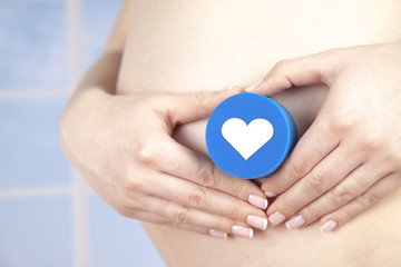 Pregnant woman holding a heart