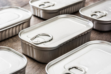 Cans of preserves on wooden table


