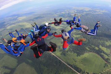 The team of skydivers is in the sky