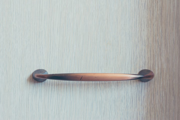 Furniture handle on wooden background