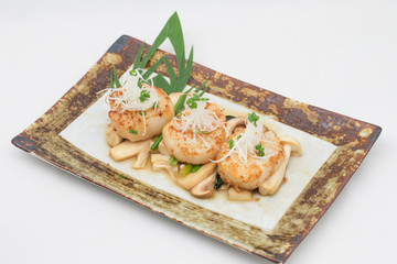 Scallop and mushroom  fried in oyster sauce on plate on white background