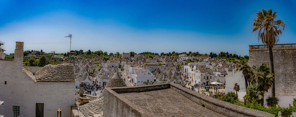 Alberobello, Puglia, Italy, Murge, a village of white trulli immersed in the blue sky.