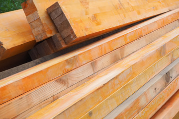 Wooden beams are covered with rust inhibitor. Fireproofing wooden structures. Wooden planks stacked pile.
