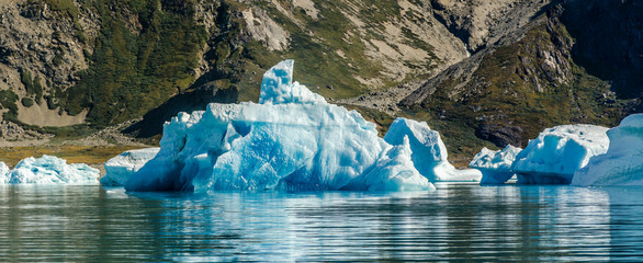Small and blue iceberg near the coast
