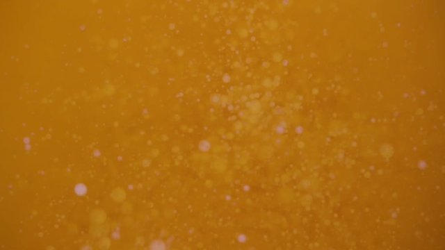 Abstract: Close-up on the surface of boiling ghee oil being prepared