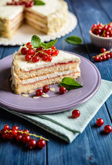 Delicious cake with mascarpone, whipped cream, red currant and almond slices