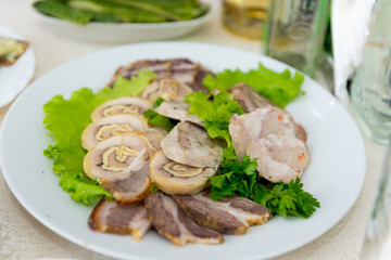 A fragrant delicious meatloaf, decorated with greenery close-up.