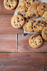 Chocolate chip cookies with napkin on brown wooden table