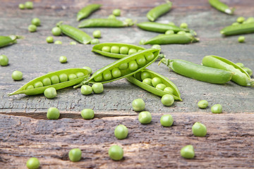 Fresh green peas on wooden table