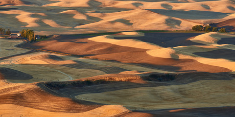 Sunrise aerial panoramic view over Palouse Hills with farmland in autumn season.