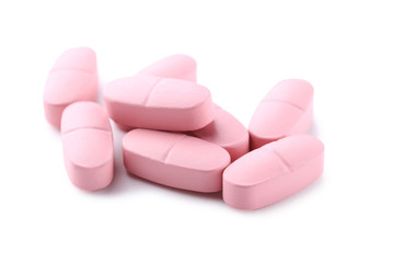 Obraz na płótnie Canvas Pink pills isolated on a white background