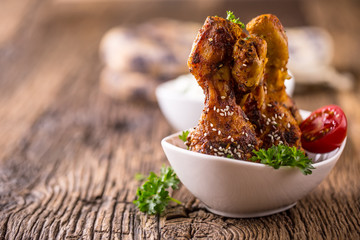 Grill chicken legs. Grilled chicken legs BBQ with sesame parsley and tomato.