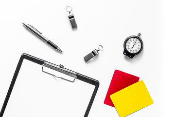 Set to judge competition. Yellow and red cards, stopwatch, whistle, pad on white background top view mockup