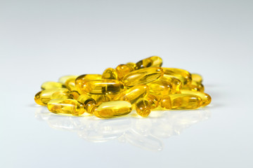 Fish oil gel capsules of omega 3. Close up capsules fish oil on white background. The supplement high vitamin E omega 3 and DHA.