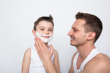 Father teaching boy to shave