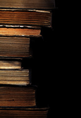Rare books stacked isolated on black background