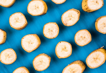 Sliced banana pattern on blue background horizontal