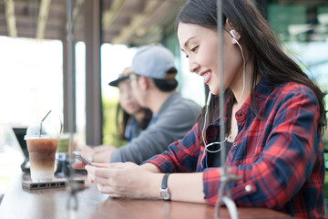 Charming beautiful young asian woman using mobile.