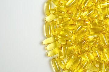 Fish oil gel capsules of omega 3. Copyspace added. Close up capsules fish oil on white background. The supplement high vitamin E omega 3 and DHA.Background