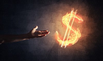 Concept of money making with dollar currency fire symbol on dark