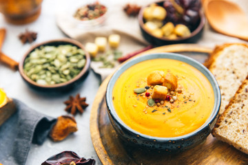 Bowl with sweet potato soup and spices.