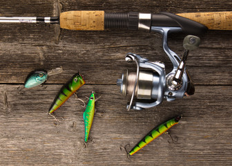 spinning rod  And bait on a wooden background